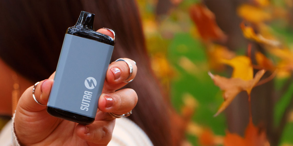 woman holding the Sutra SILO Pro with fall leaves in background